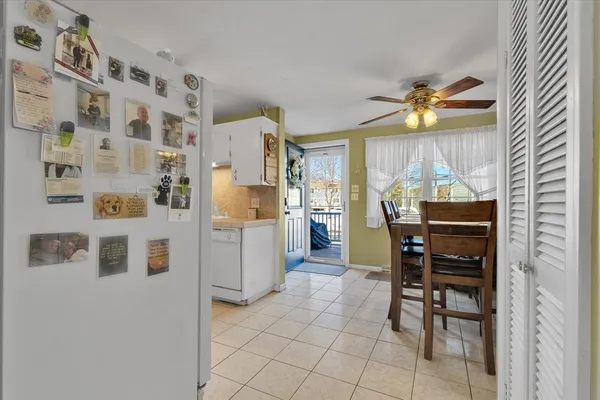 a kitchen with a refrigerator and chairs