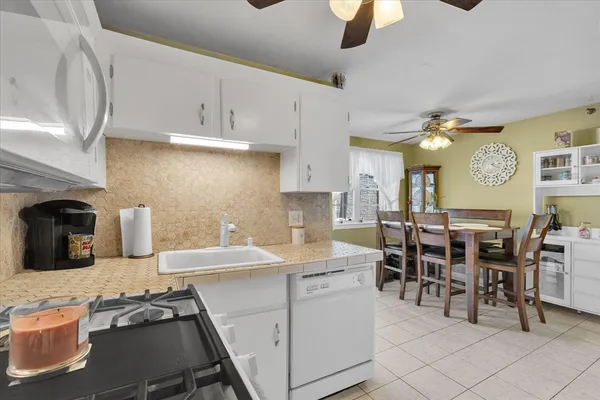 a kitchen with cabinets and chairs