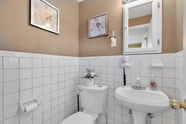 a bathroom with a sink mirror and toilet