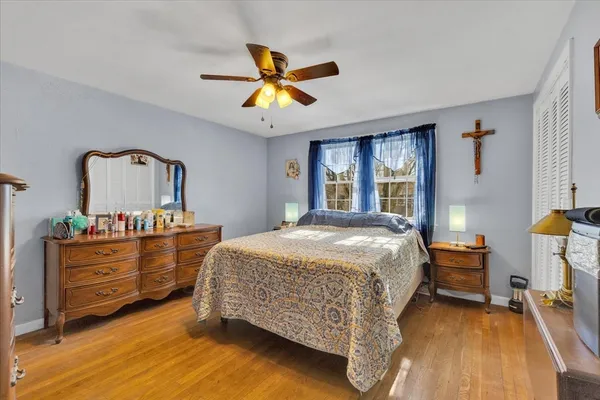 a bed sitting in a bedroom next to a window