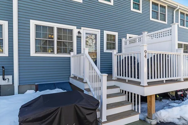 a view of a house with wooden deck and furniture
