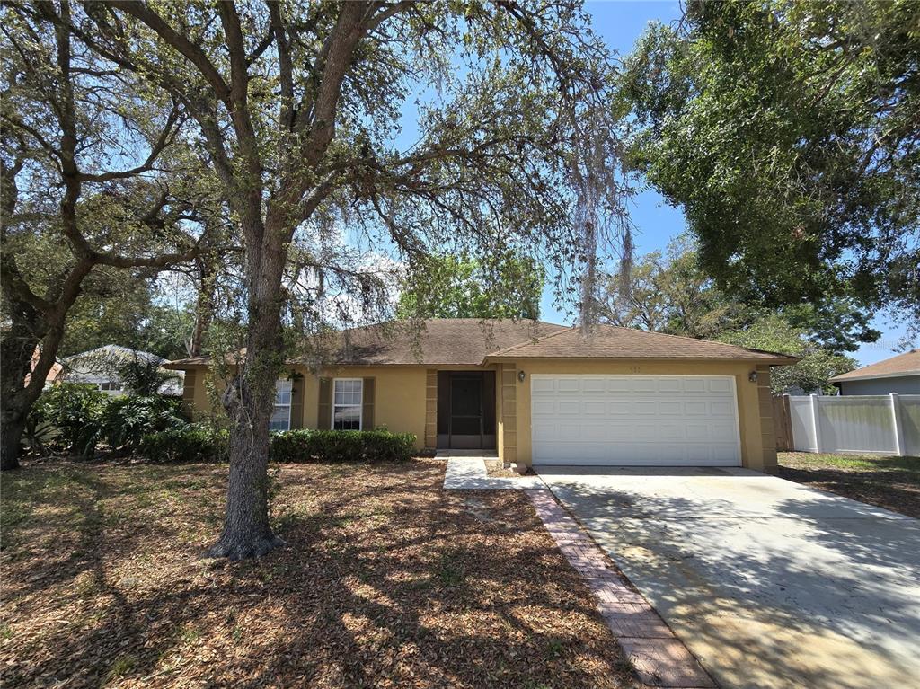 a front view of house with yard and trees