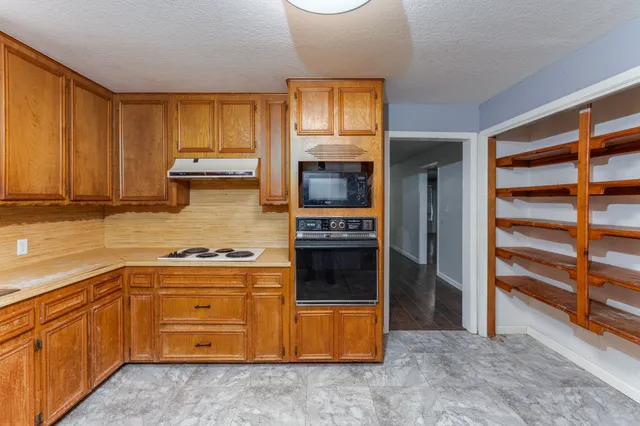 a kitchen with a stove and a microwave