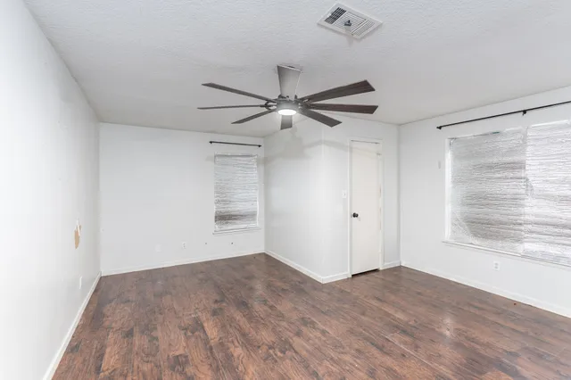 a view of a livingroom with a ceiling fan and window
