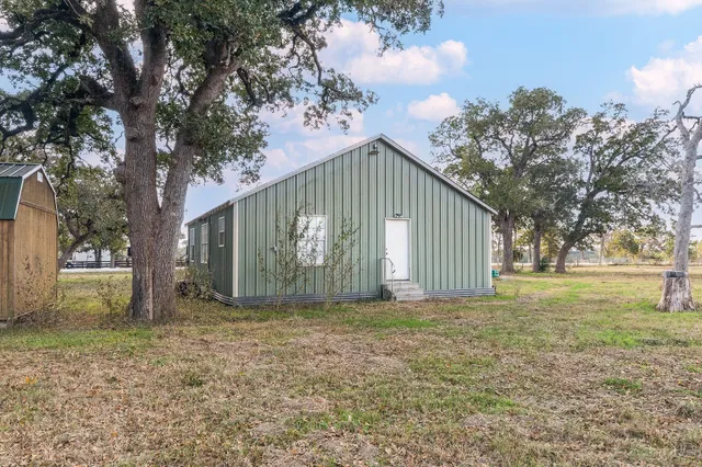 a view of a house with a yard and tree