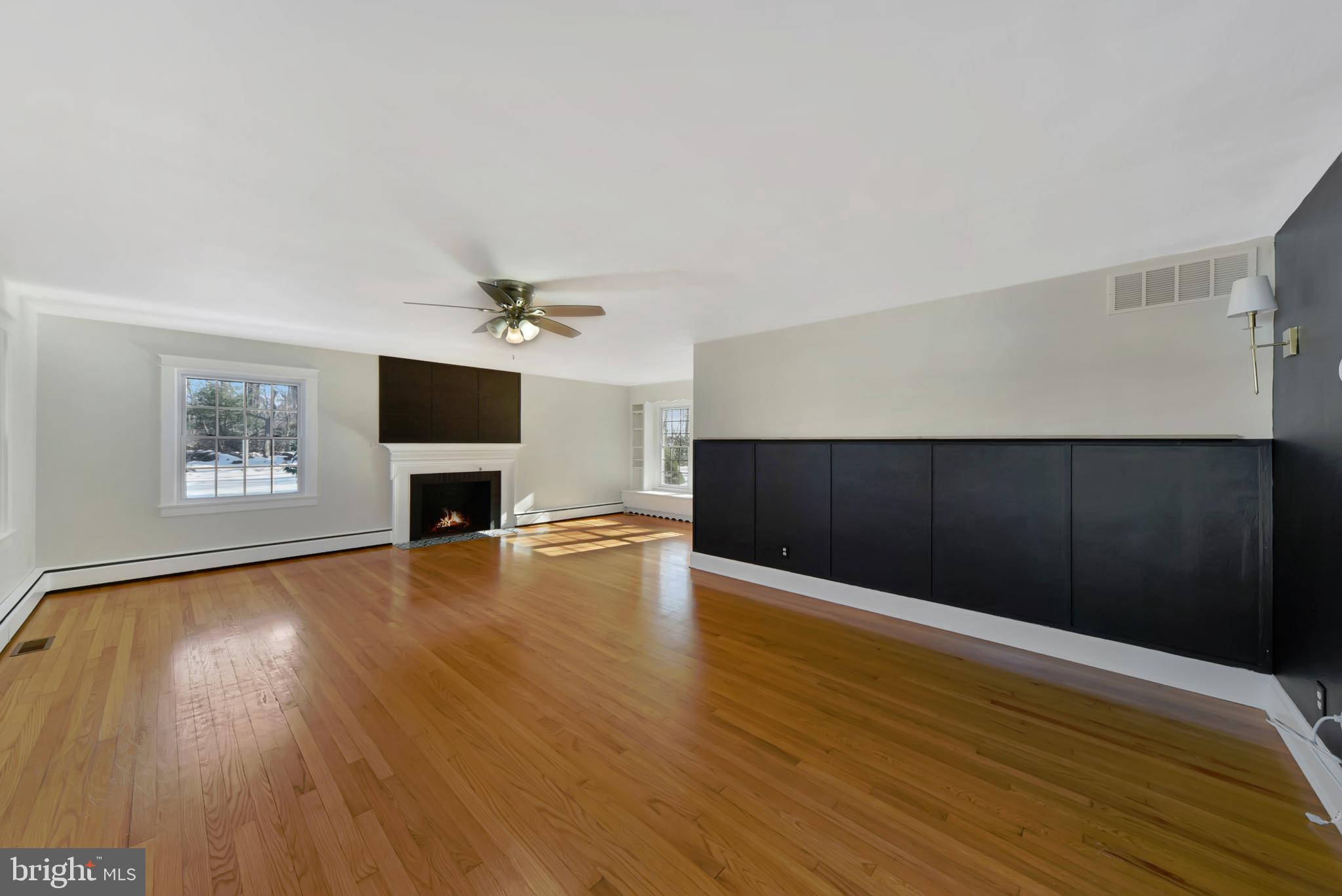 2675 Jolly Acres Road White Hall, MD 21161 - Photo 5 of 50 a view of an empty room with wooden floor and a fireplace