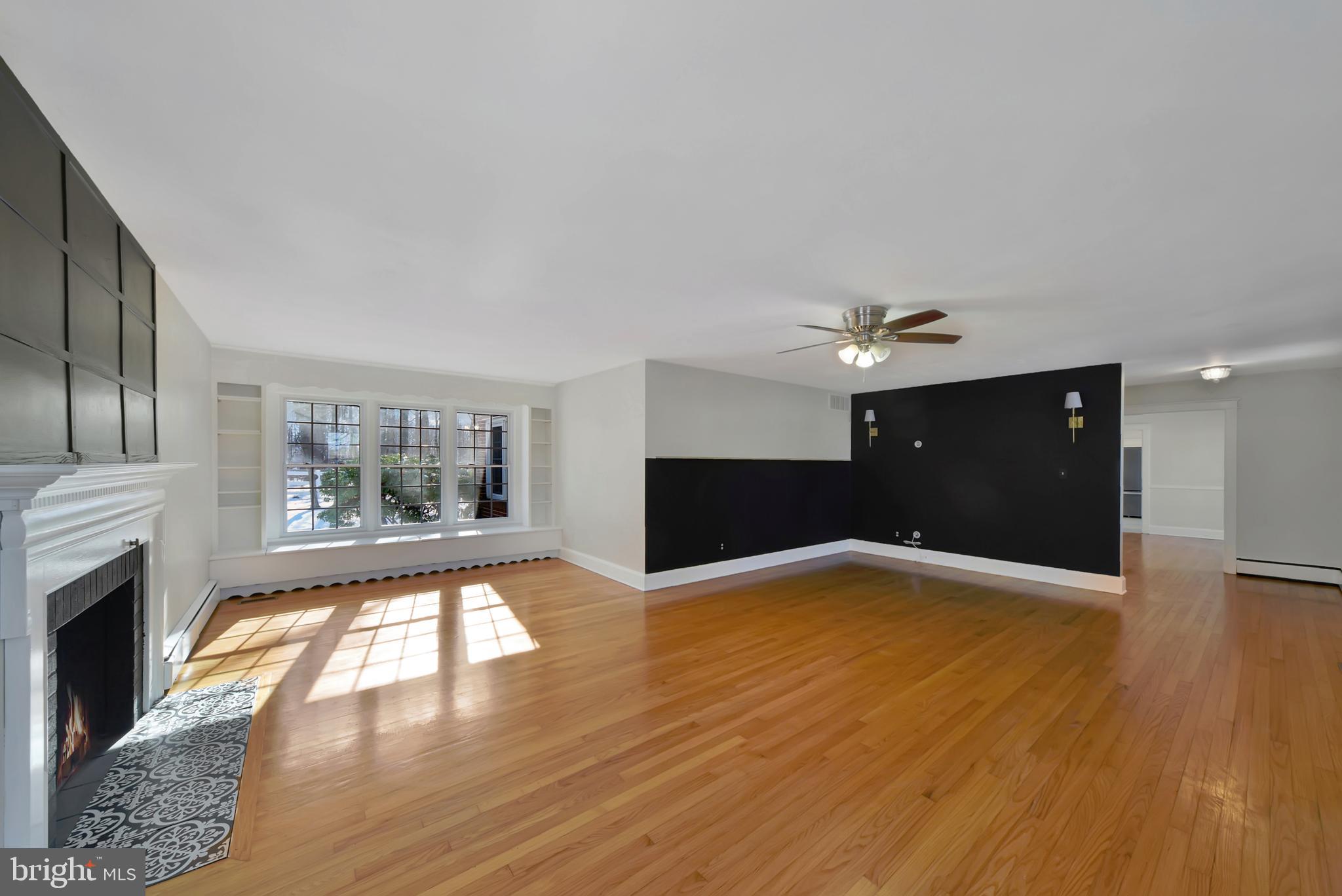 2675 Jolly Acres Road White Hall, MD 21161 - Photo 6 of 50 a view of empty room with wooden floor and fireplace