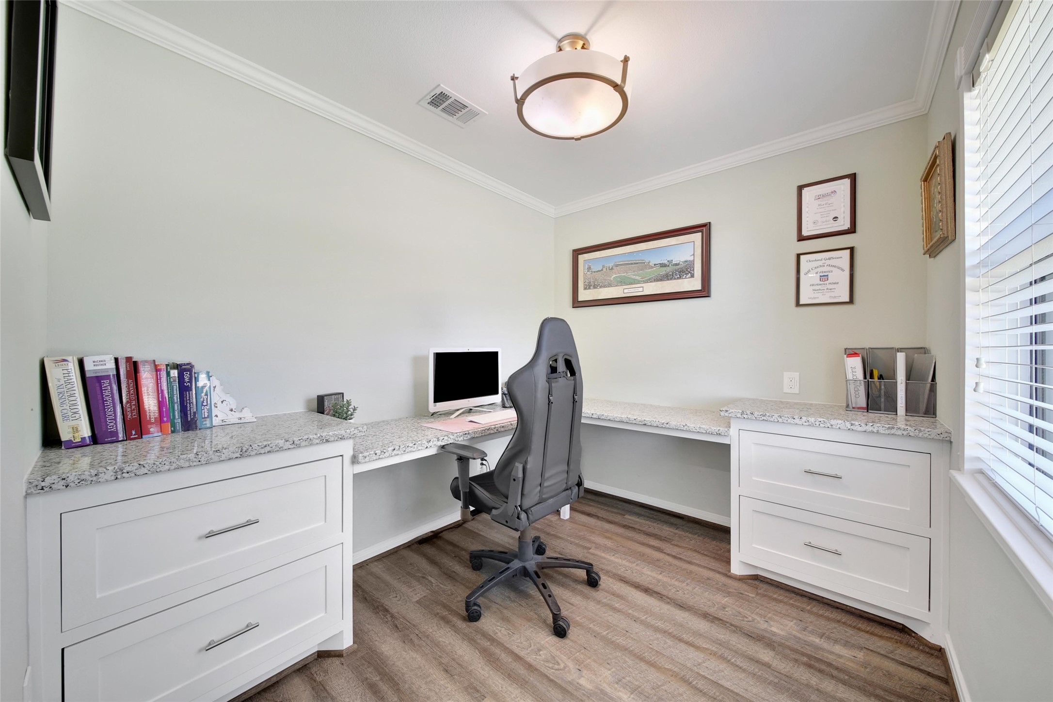4402 Fallbrook Drive Houston, TX 77018 - Photo 12 of 29 Well-appointed home office featuring built-in cabinetry, spacious work surfaces, and updated flooring.