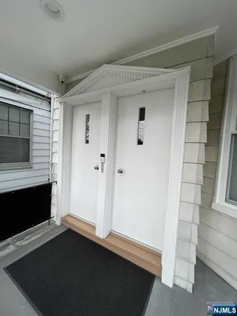 a view of empty room with wooden floor and fireplace