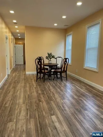 a dining room with furniture and wooden floor