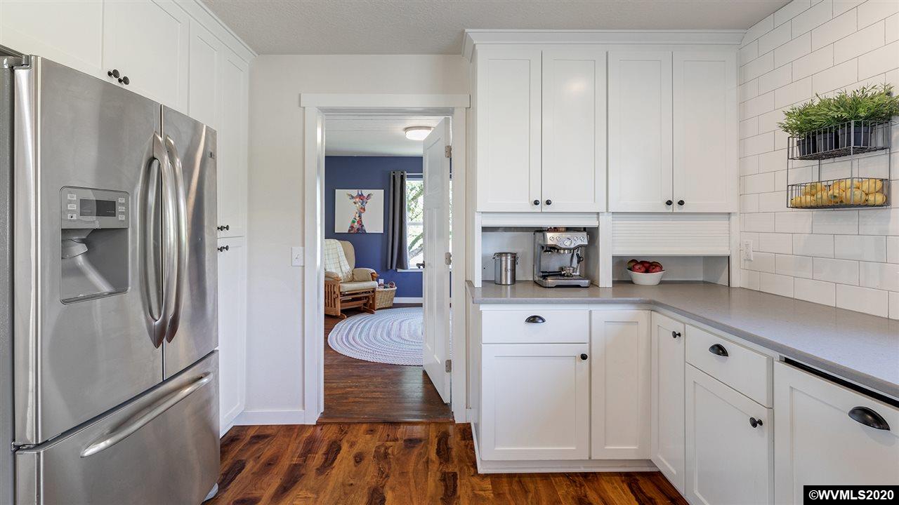 790 Southeast Fir Villa Road Dallas, OR 97338 - Photo 14 of 38 a kitchen with stainless steel appliances a refrigerator sink and cabinets