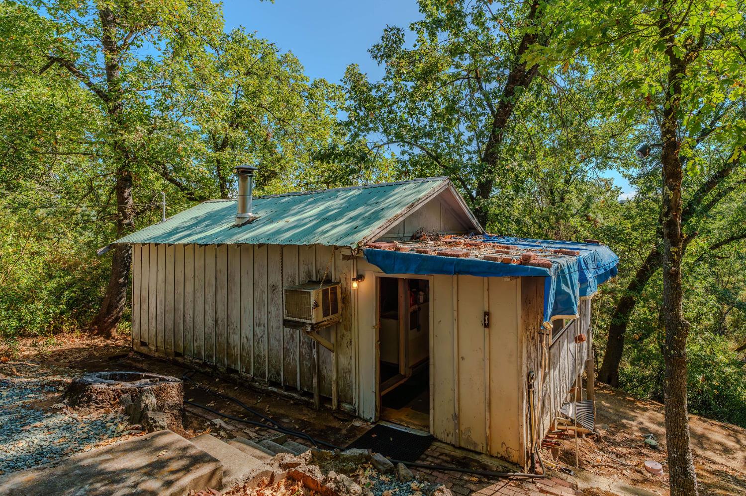 a view of a small house with wooden fence
