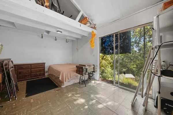 a bedroom with a bed and a large mirror on the dresser