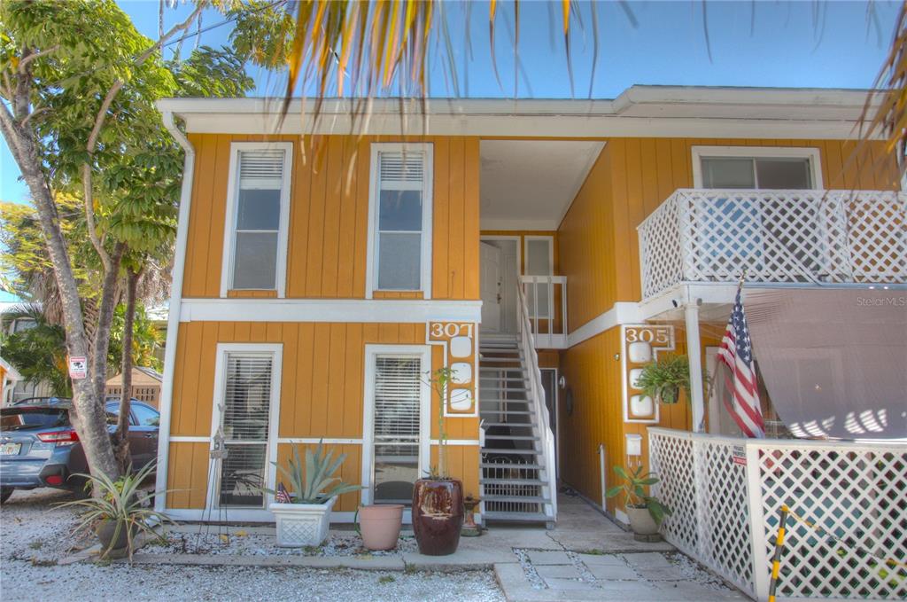 307 South Osprey Avenue, Unit 307 Sarasota, FL 34236 - Photo 1 of 8 a front view of a house with wooden fence