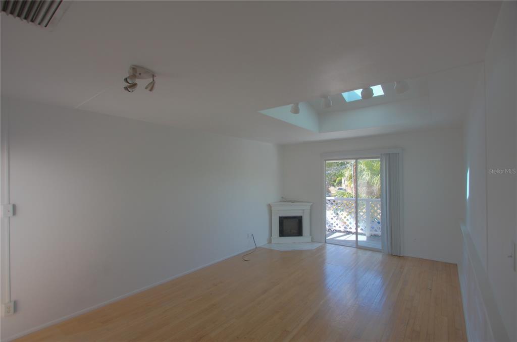 307 South Osprey Avenue, Unit 307 Sarasota, FL 34236 - Photo 2 of 8 a view of empty room with wooden floor and fan