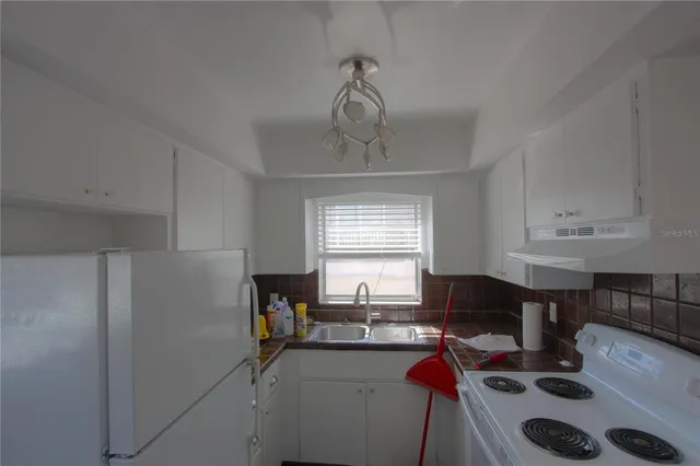 a view of a workspace with furniture and window