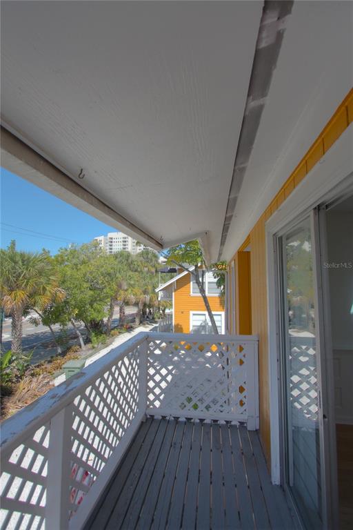 307 South Osprey Avenue, Unit 307 Sarasota, FL 34236 - Photo 5 of 8 a view of a balcony with wooden floor