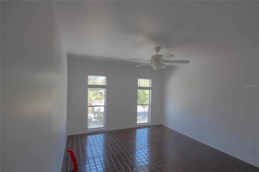 307 South Osprey Avenue, Unit 307 Sarasota, FL 34236 - Photo 7 of 8 an empty room with wooden floor and windows