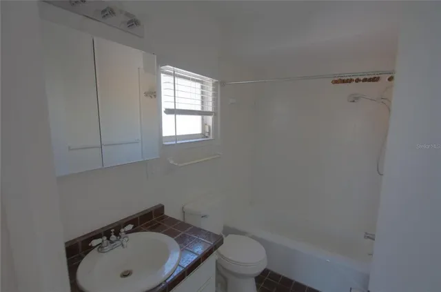 a bathroom with a sink toilet and vanity
