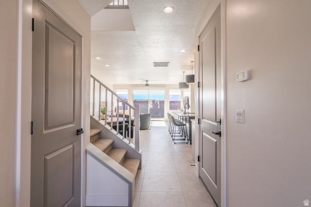 2972 West 570 North Hurricane, UT 84737 - Photo 19 of 104 Corridor featuring recessed lighting, a textured ceiling, and light tile patterned flooring