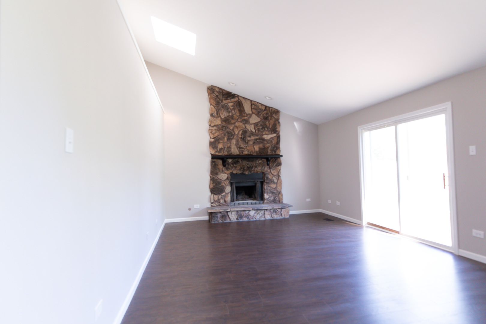 56 White Oaks Road Matteson, IL 60443 - Photo 11 of 20 a view of an empty room with wooden floor fireplace and a window
