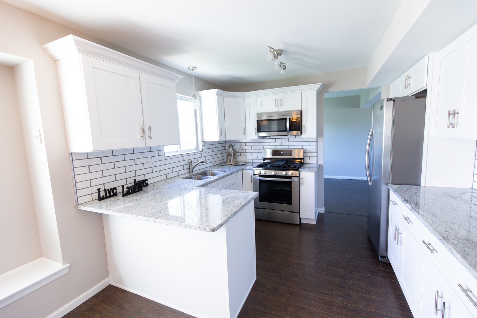 56 White Oaks Road Matteson, IL 60443 - Photo 3 of 20 a kitchen with stainless steel appliances granite countertop a sink stove microwave and refrigerator