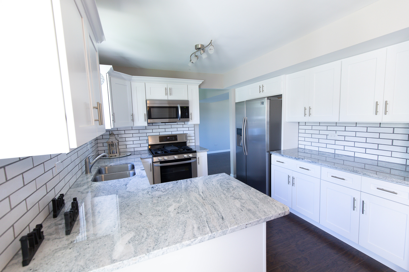 56 White Oaks Road Matteson, IL 60443 - Photo 6 of 20 a kitchen with stainless steel appliances granite countertop a sink stove microwave and refrigerator