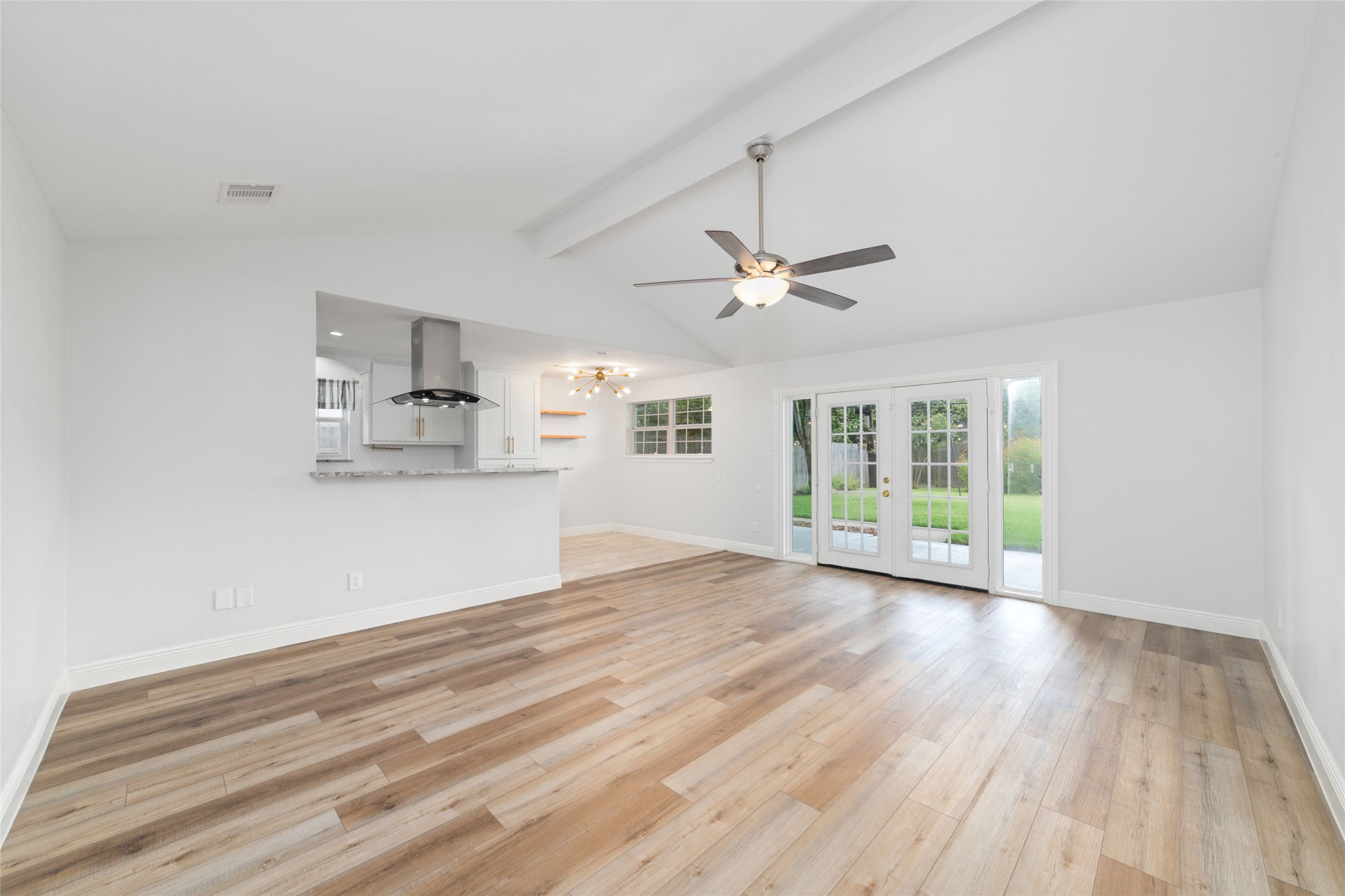 5922 Hummingbird Street Houston, TX 77096 - Photo 8 of 26 Large windows frame views of the backyard while bringing natural light into the heart of the home. It's a space that feels equally comfortable entertaining a crowd or enjoying a quiet night in. No rear neighbors is a big plus.