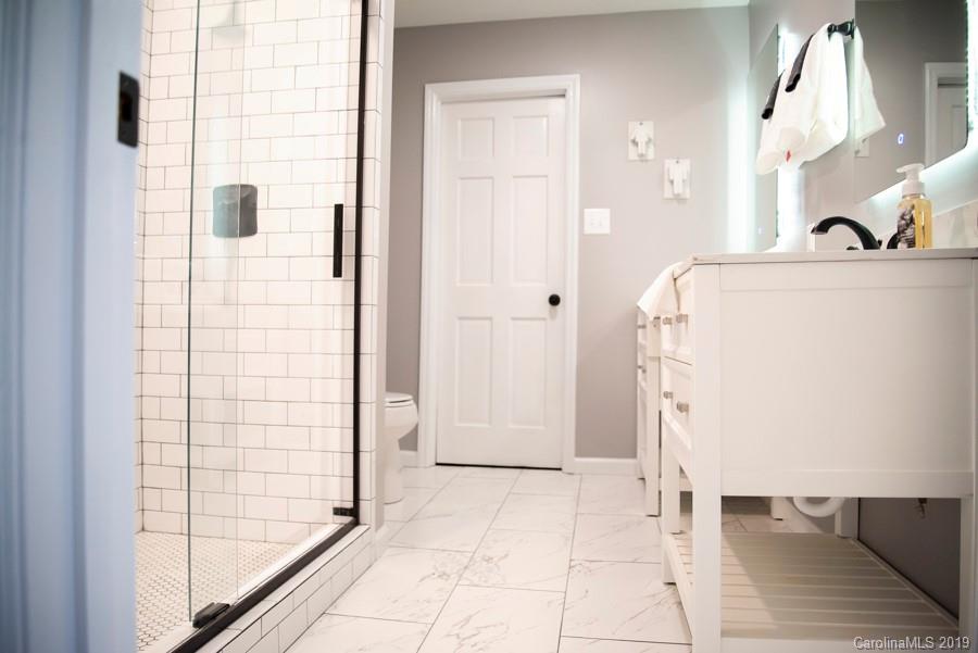15016 Ranson Road Huntersville, NC 28078 - Photo 21 of 27 a bathroom with a bathtub and a shower