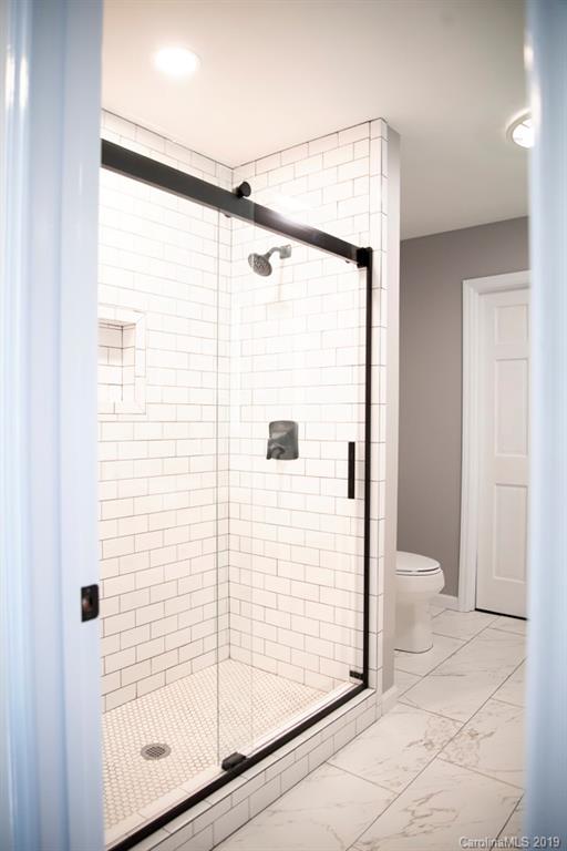 15016 Ranson Road Huntersville, NC 28078 - Photo 22 of 27 a bathroom with a shower and a toilet