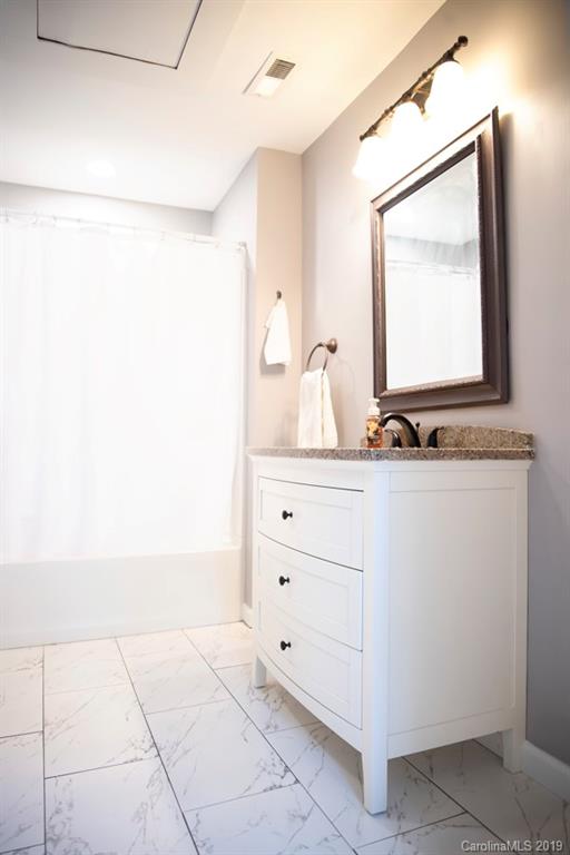 15016 Ranson Road Huntersville, NC 28078 - Photo 23 of 27 a bathroom with a bathtub and a sink