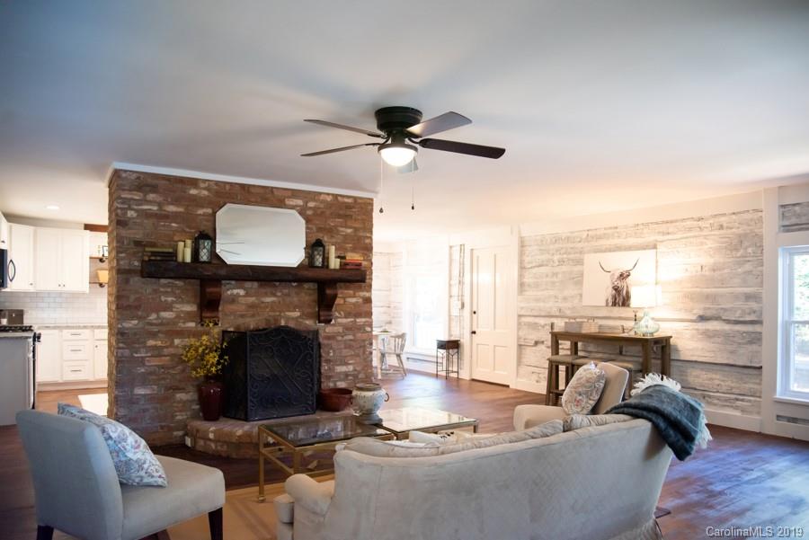 15016 Ranson Road Huntersville, NC 28078 - Photo 10 of 27 a living room with furniture a fireplace and a table