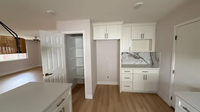 a view of hallway with wooden floor