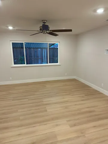 a kitchen with a sink a stove a refrigerator and white cabinets