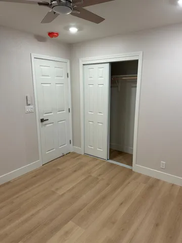 an empty room with windows and closet