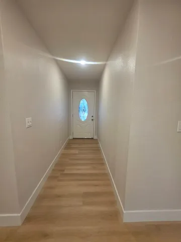a view of a kitchen with a sink and a refrigerator
