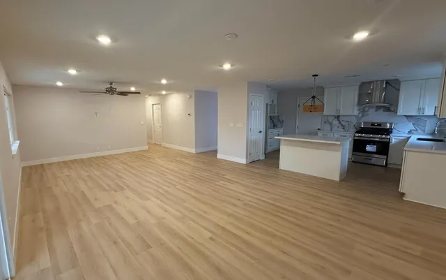 a kitchen with kitchen island granite countertop a sink stainless steel appliances and cabinets