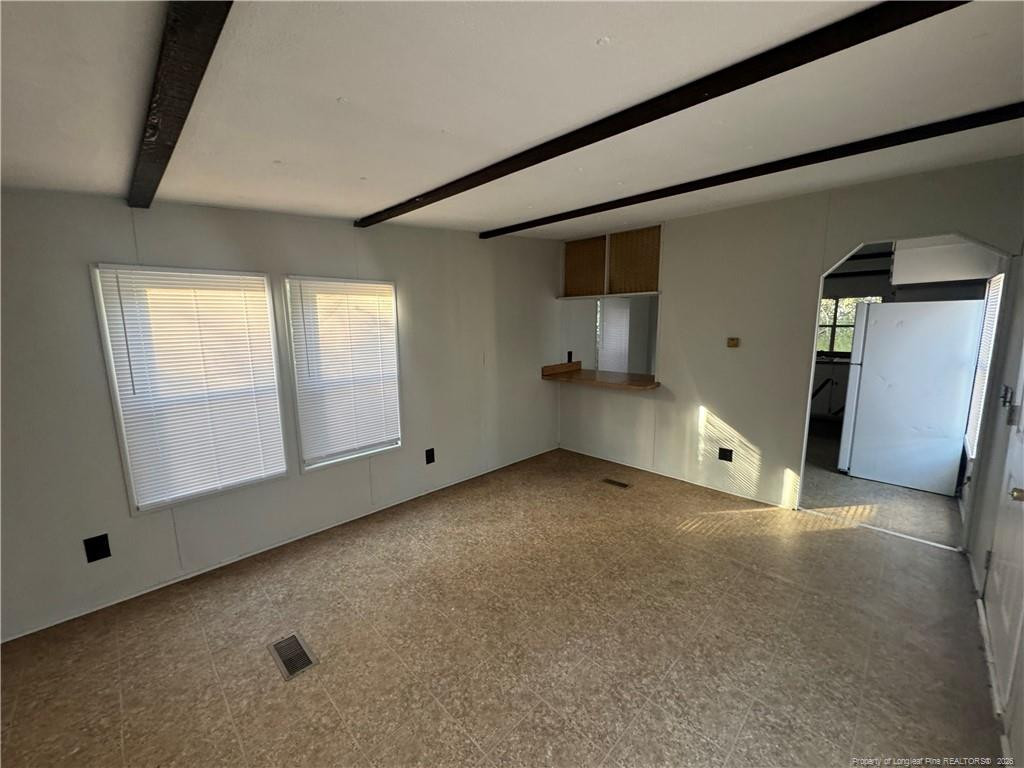 1738 Strickland Bridge Road Fayetteville, NC 28304 - Photo 2 of 9 a view of a livingroom with wooden floor and windows