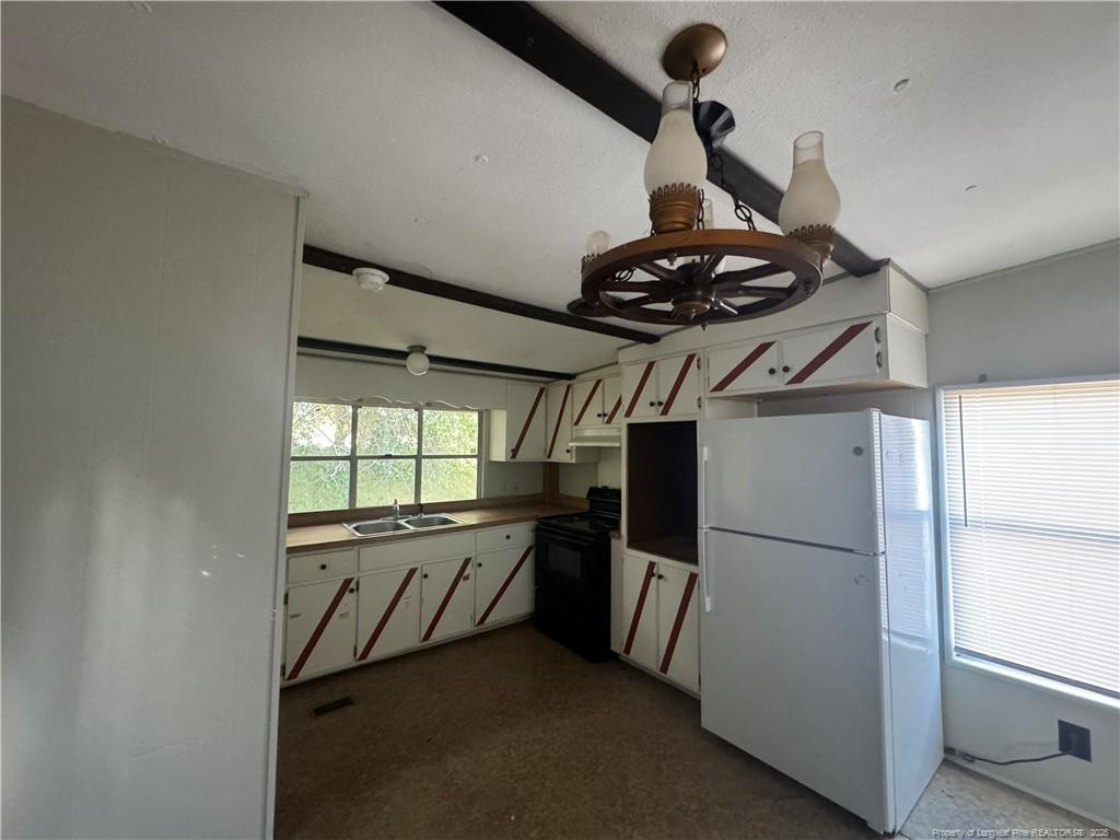 1738 Strickland Bridge Road Fayetteville, NC 28304 - Photo 4 of 9 a kitchen with stainless steel appliances a refrigerator and a stove top oven