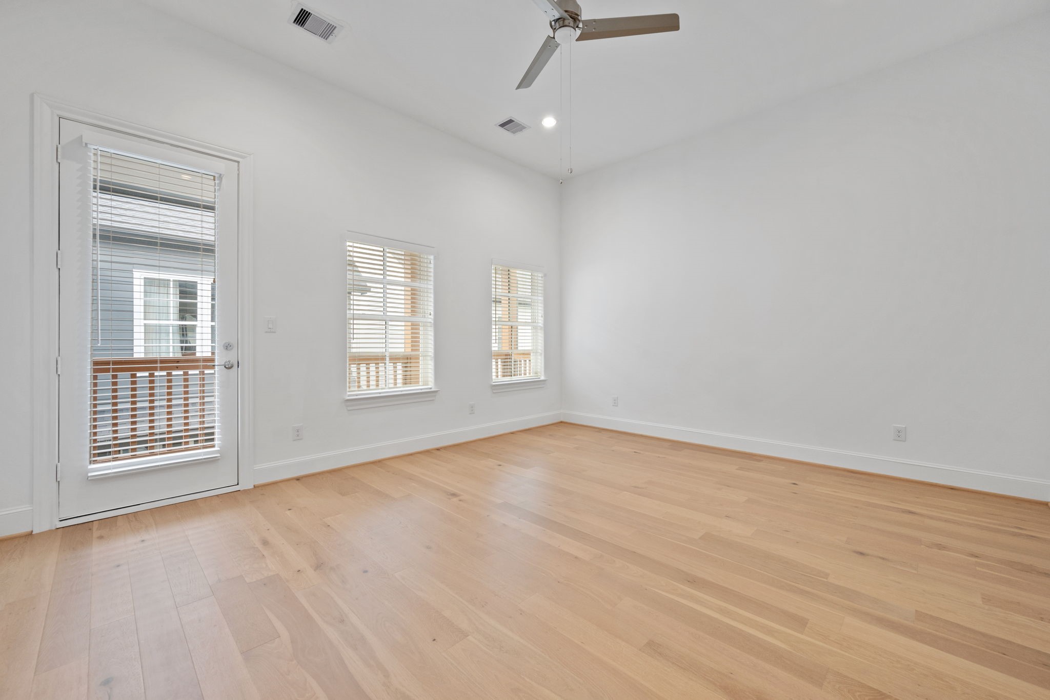 614 Delmar Street Houston, TX 77023 - Photo 22 of 36 a view of an empty room with a window and wooden floor
