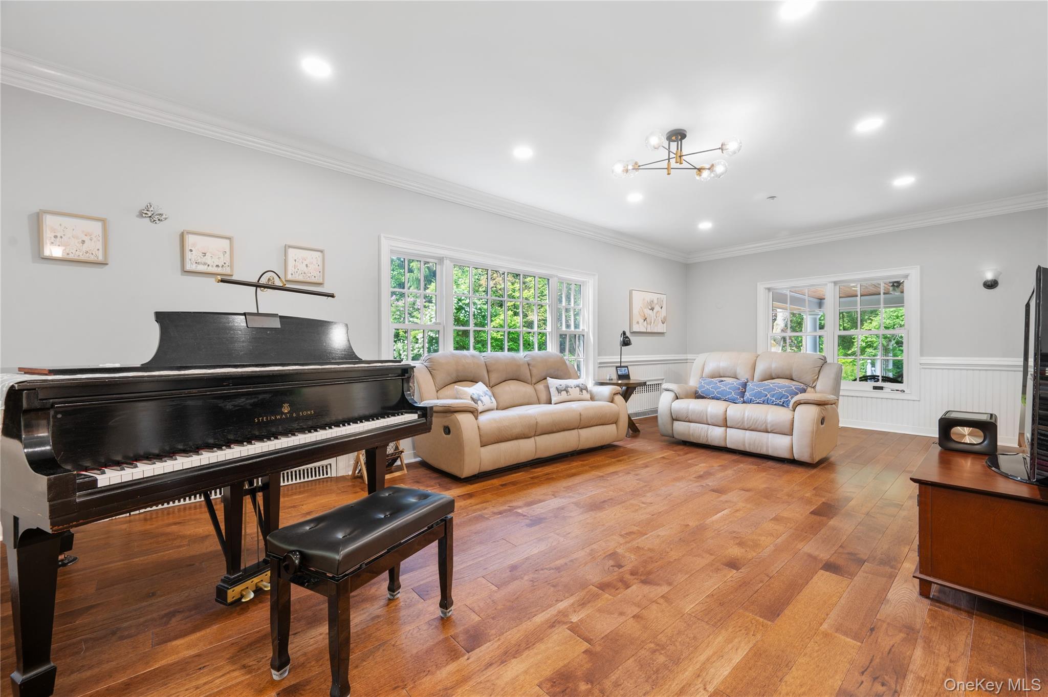 22 Crane Road Scarsdale, NY 10583 - Photo 5 of 32 Spacious Family Room stretches across the entire back of the home, surrounded by windows on every side.