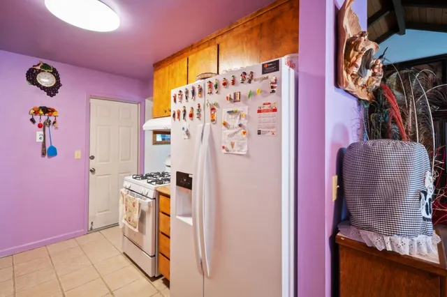 a kitchen with stainless steel appliances granite countertop a refrigerator and a stove