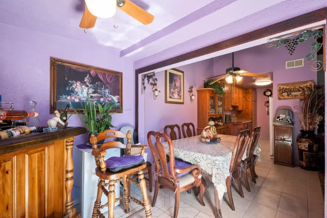 a view of a dining room with furniture and chandelier