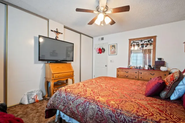 a bedroom with a bed and flat screen tv