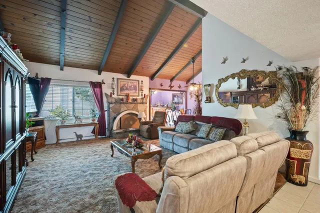 a living room with furniture a flat screen tv and a large window