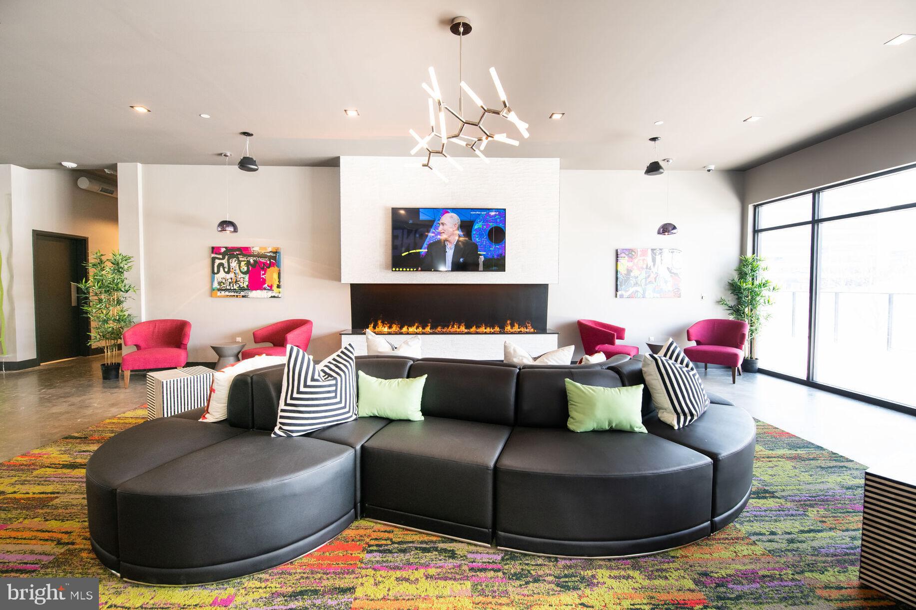 9 Presidential Boulevard, Unit 1B108 Bala Cynwyd, PA 19004 - Photo 15 of 20 a living room with furniture and a chandelier