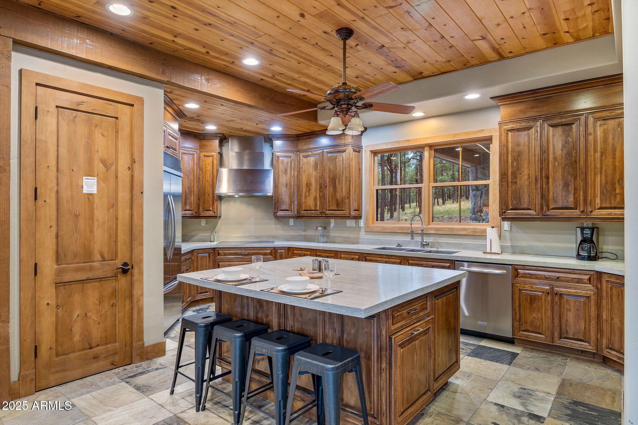 36 County Road N2147 Alpine, AZ 85920 - Photo 14 of 47 a kitchen with a table chairs refrigerator and cabinets