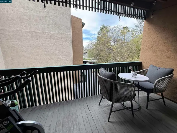 a view of a chairs and table in the balcony