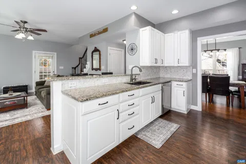 a kitchen with a center island appliances and cabinets
