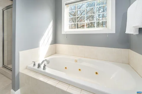 a bathroom with a tub and a window